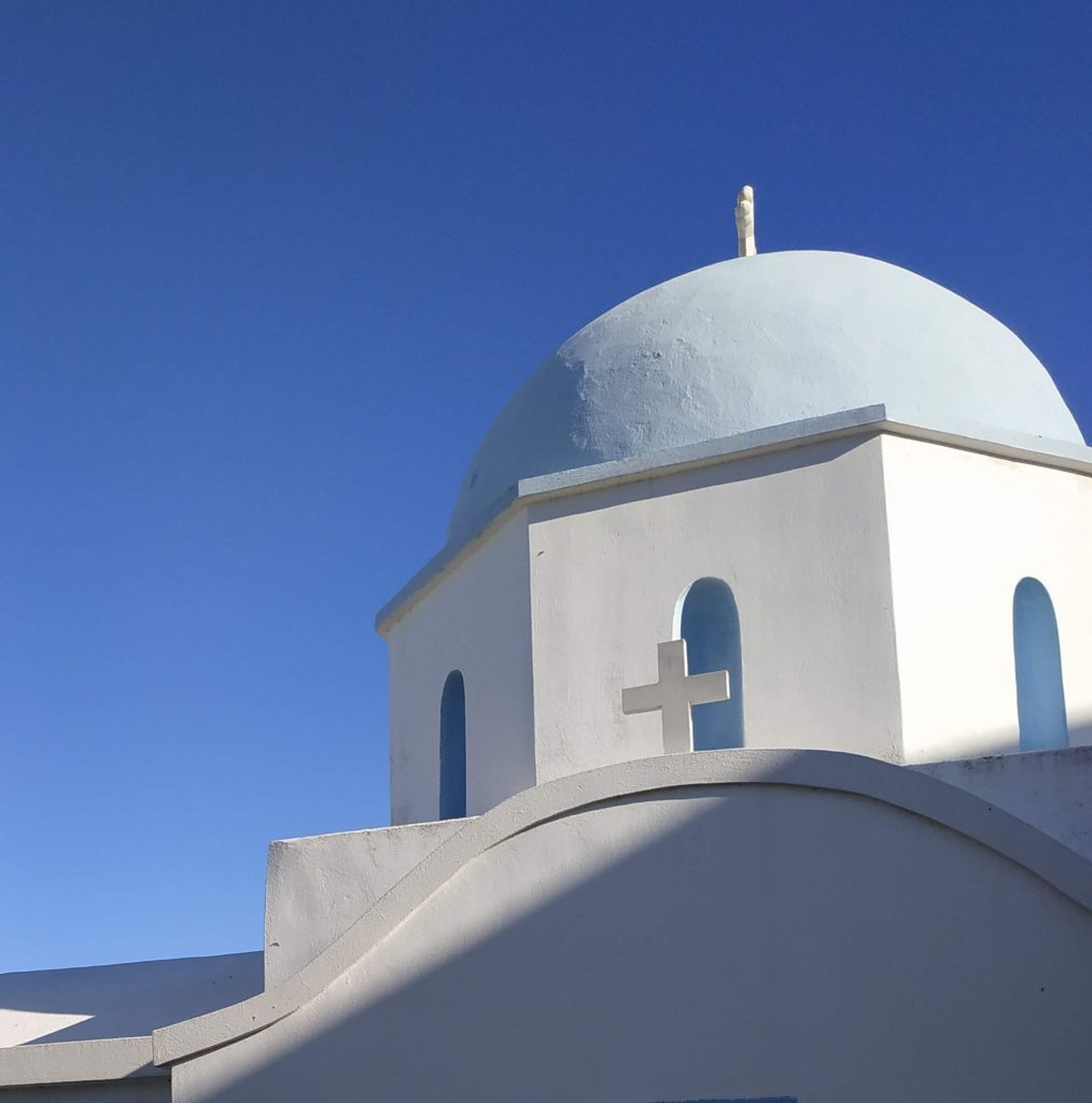 Petite église cycladique blanche au dôme bleu à Paros, image emblématique pour préparer un voyage en Grèce en famille